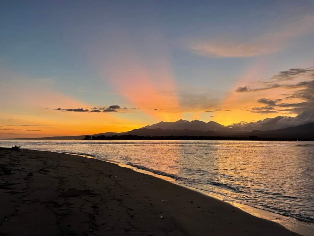 Sunset over the sea from the beach on Gili Meno